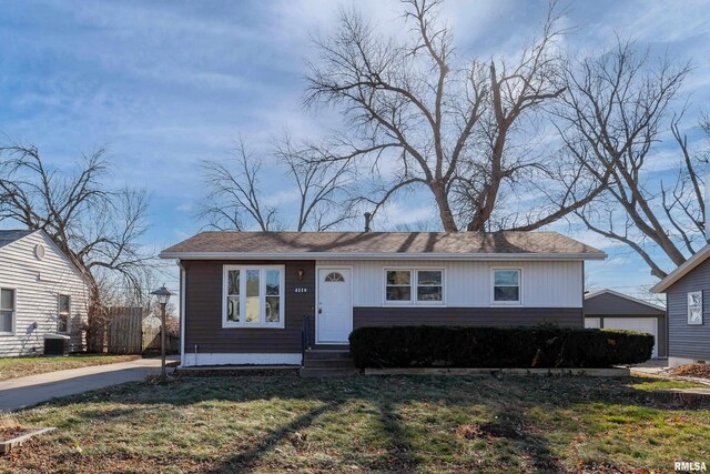 view of front of property with cooling unit and a front lawn