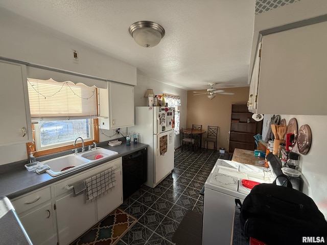 kitchen with white refrigerator, sink, dark tile patterned floors, black dishwasher, and white cabinetry