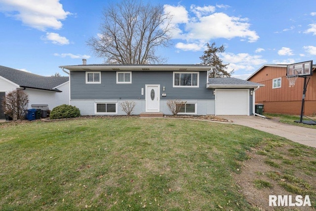 bi-level home featuring a front yard and a garage