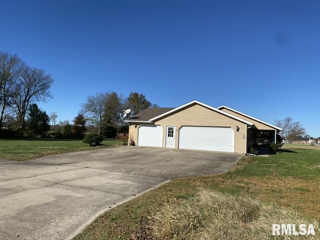 view of side of property featuring a garage and a lawn