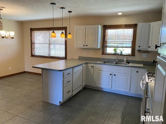 kitchen with kitchen peninsula, white dishwasher, white cabinetry, and sink