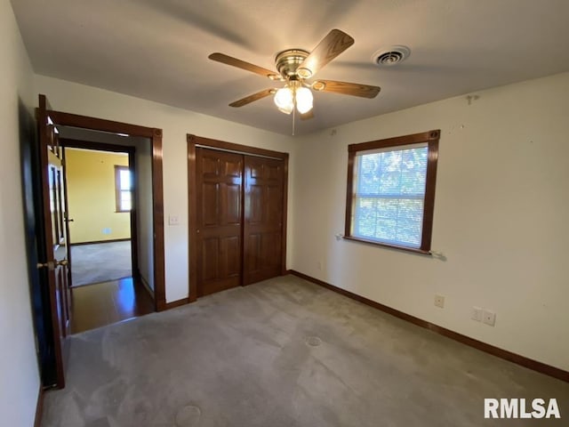 unfurnished bedroom with carpet flooring, a closet, and ceiling fan