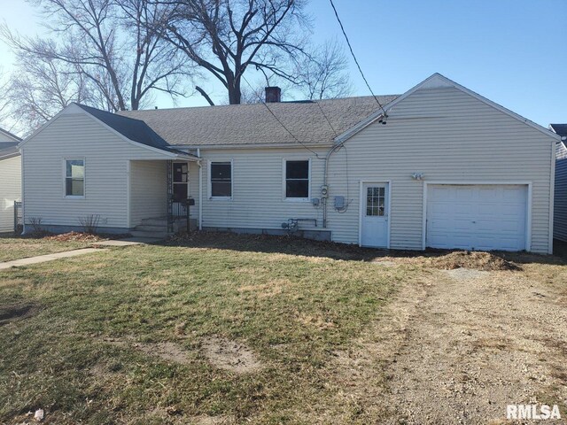 view of front facade with a front yard and a garage