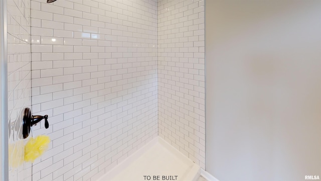 bathroom with a tile shower