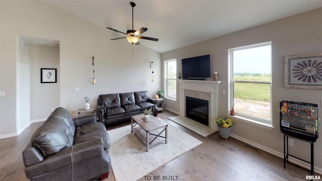 living room featuring ceiling fan, a fireplace, wood-type flooring, and lofted ceiling