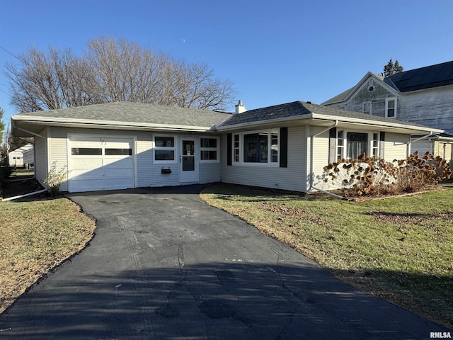 single story home with a garage and a front lawn