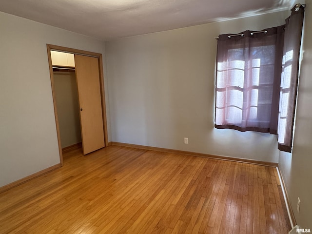 unfurnished bedroom featuring a closet and light hardwood / wood-style flooring