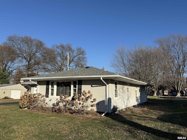 view of side of home featuring a yard and a garage