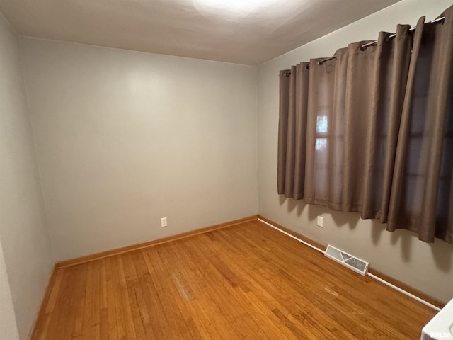 empty room with wood-type flooring