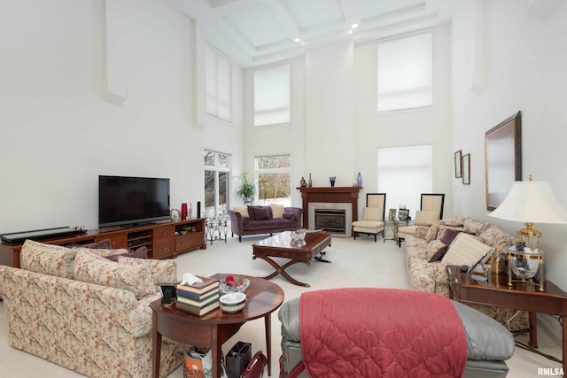 living room with beamed ceiling, a towering ceiling, and carpet floors