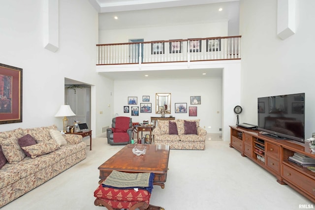 carpeted living room with a high ceiling