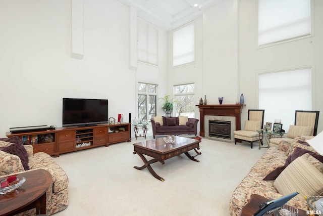 carpeted living room with a high ceiling