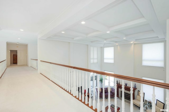 hall featuring light carpet, beamed ceiling, and coffered ceiling