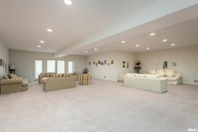 carpeted living room featuring beamed ceiling