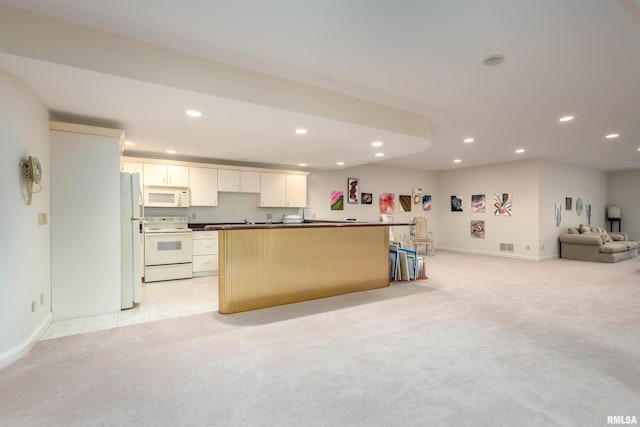 kitchen featuring white cabinets, light carpet, white appliances, and a center island