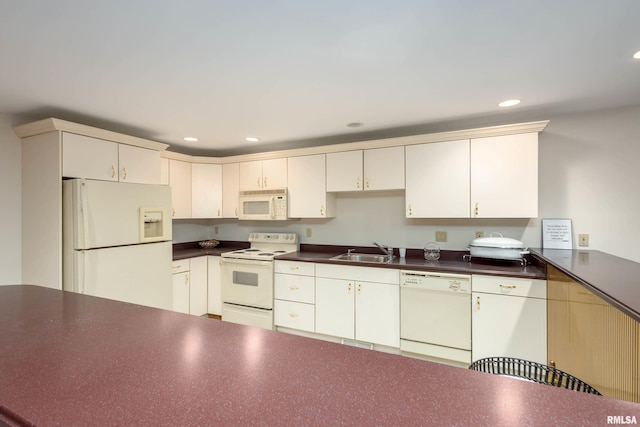 kitchen featuring cream cabinets, white appliances, and sink