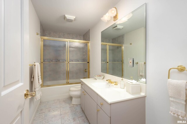 full bathroom with tile patterned flooring, vanity, toilet, and bath / shower combo with glass door