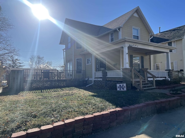 view of front of house with a porch and a front yard