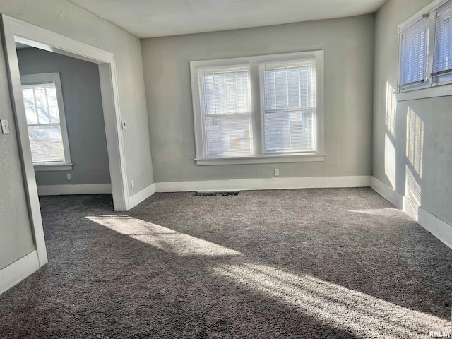 empty room with dark colored carpet