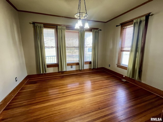 1812 E 1650th St, Paloma, IL 62359 - spare room with a chandelier, hardwood / wood-style floors, a wealth of natural light, and crown molding