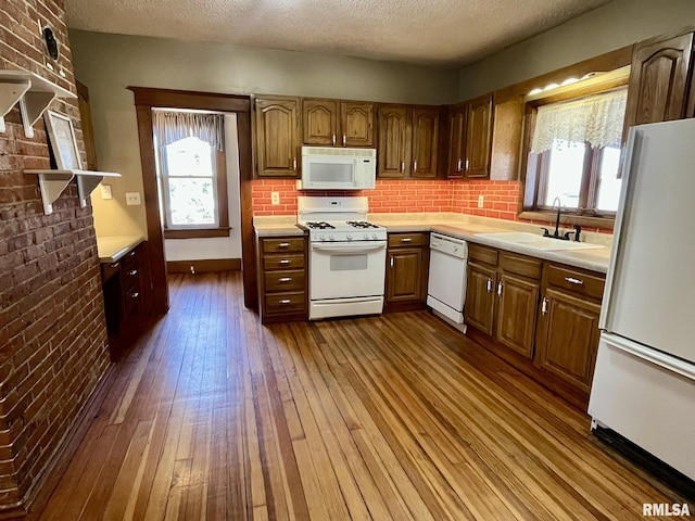 1812 E 1650th St, Paloma, IL 62359 - kitchen featuring a textured ceiling, white appliances, dark wood-type flooring, and sink