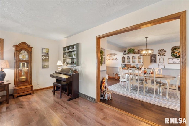 interior space featuring a chandelier, a textured ceiling, and light hardwood / wood-style flooring