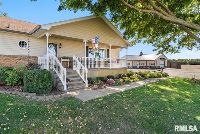 view of front of home with a porch and a front yard