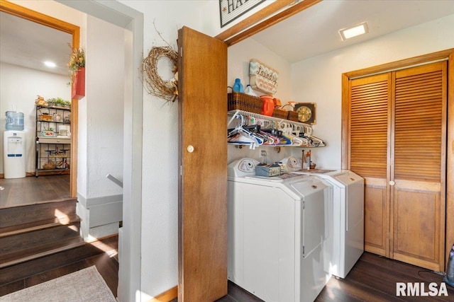 clothes washing area featuring separate washer and dryer and dark hardwood / wood-style floors