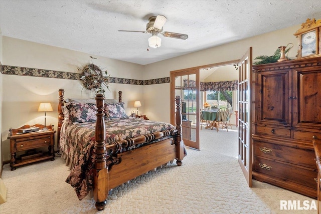 bedroom featuring ceiling fan, french doors, light colored carpet, and a textured ceiling