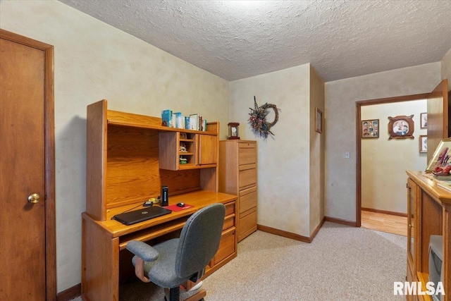 carpeted office with a textured ceiling