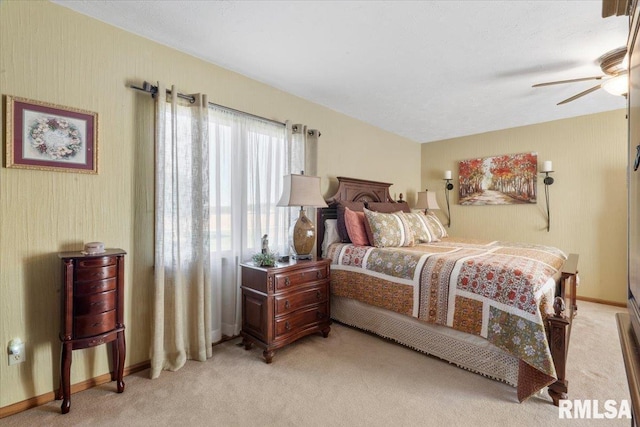 bedroom featuring ceiling fan and light carpet