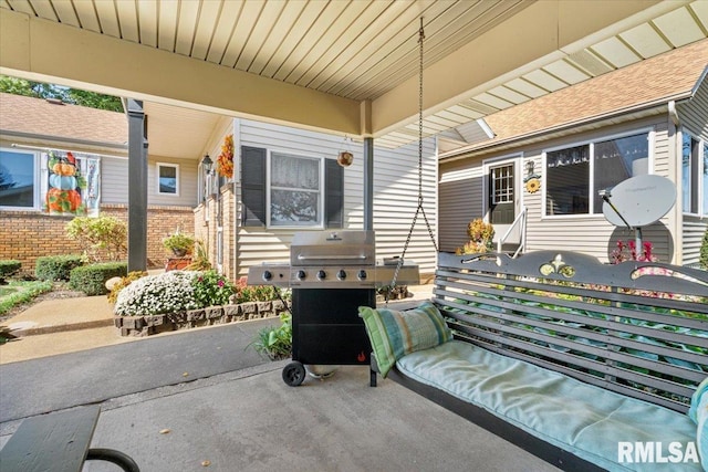 view of patio with area for grilling and a porch