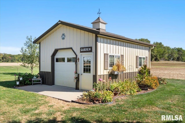 garage featuring a lawn