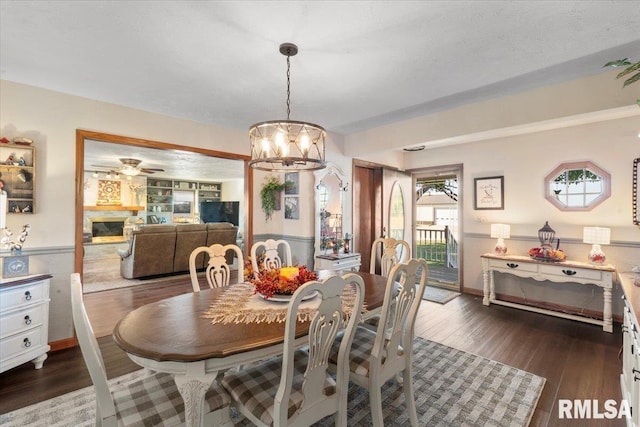 dining room featuring dark wood-type flooring and an inviting chandelier