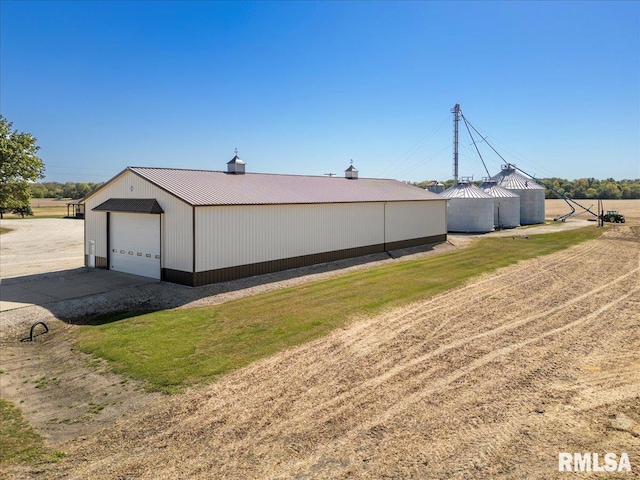 exterior space with an outbuilding and a garage