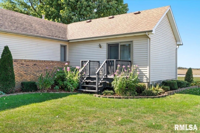 rear view of house featuring a yard