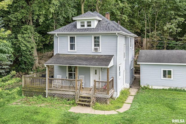 view of front of property with an outbuilding and a front yard