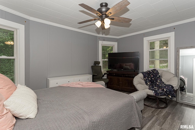 bedroom with hardwood / wood-style flooring, ceiling fan, and crown molding