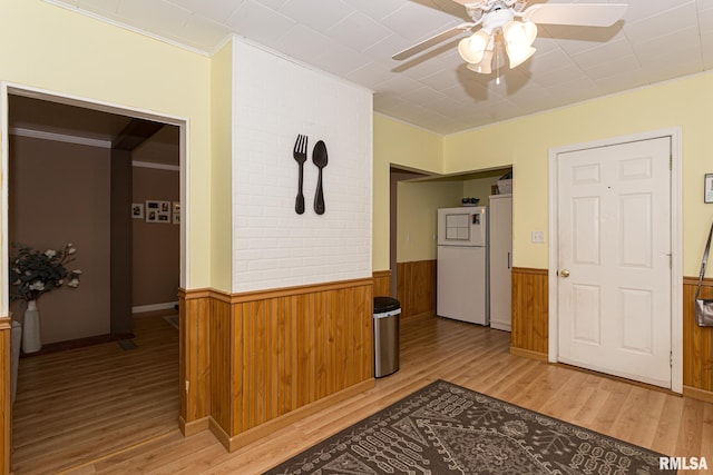 corridor with crown molding and light wood-type flooring