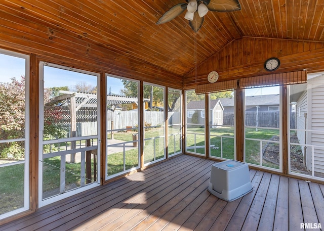 unfurnished sunroom featuring wooden ceiling, ceiling fan, a healthy amount of sunlight, and vaulted ceiling