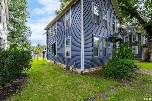 view of home's exterior with a lawn