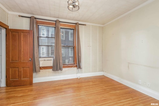 empty room with light hardwood / wood-style flooring and crown molding