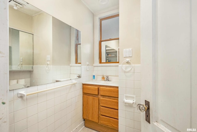 bathroom featuring vanity and tile walls