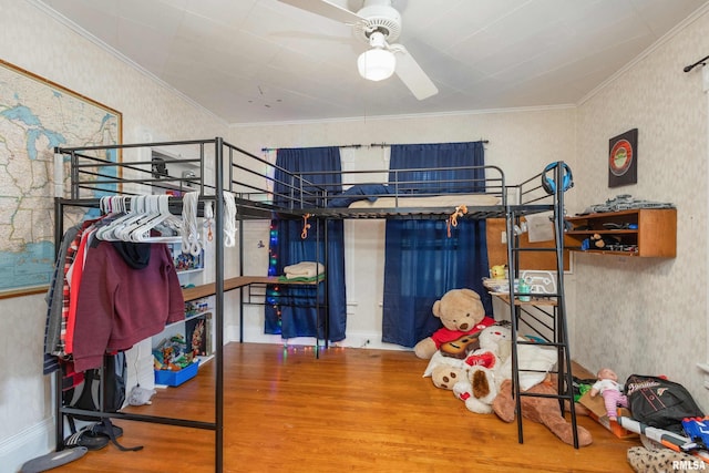 bedroom featuring ceiling fan, ornamental molding, and hardwood / wood-style flooring