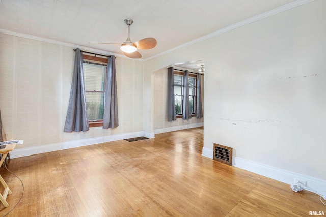 unfurnished room featuring ceiling fan, hardwood / wood-style floors, and ornamental molding