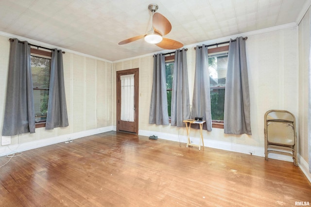 interior space featuring crown molding, ceiling fan, and wood-type flooring