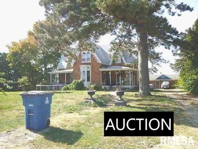 view of front of home with a front lawn and covered porch