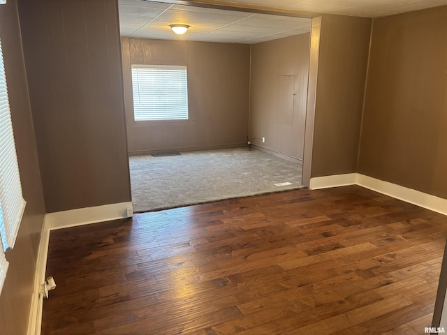 empty room with dark hardwood / wood-style floors