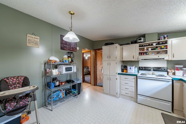 kitchen with white cabinetry, exhaust hood, decorative light fixtures, and electric range oven