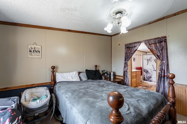 bedroom with a textured ceiling, ceiling fan, and ornamental molding